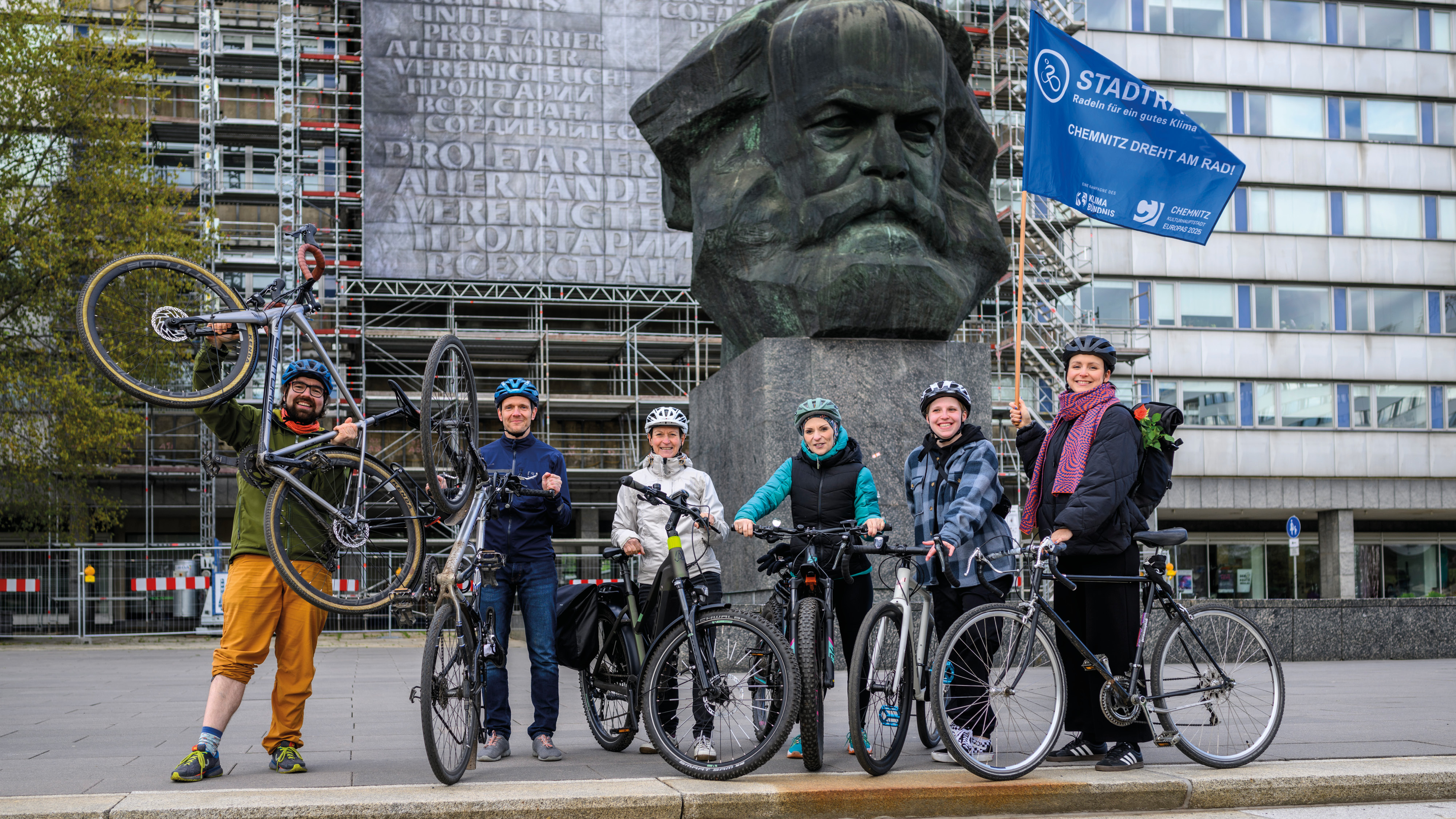 Fahrradfahrende vor dem Karl-Marx-Monument